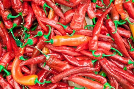 Red peppers background texture of hot red chili, seasoning paprika, fiery red hot in the kitchen a dish of red pepper for saleの写真素材