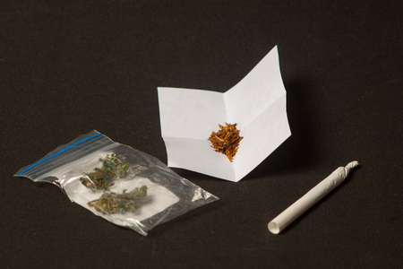 hemp buds with a smoking tube for medical marijuana and cannabis seeds for hemp oilの写真素材