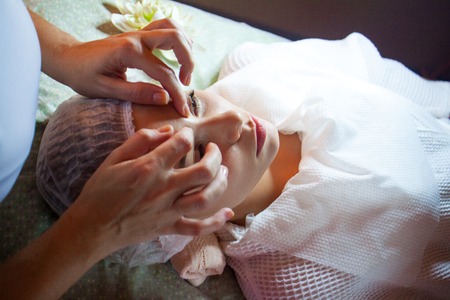 spa salon face massage. Close-up of a young woman getting spa treatment at beauty salon. spa face massage. facial beauty treatment.の写真素材