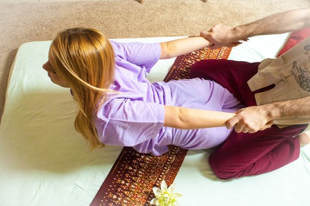 therapeutic massage manual therapy for curing pain in the joints of the osteochondrosis of the spine of muscle relaxationの写真素材