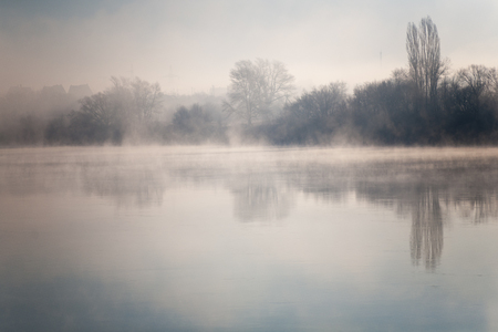 Morning on the river early morning reeds mist fog and water surface on the riverの写真素材