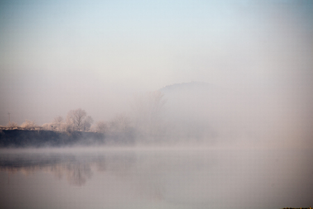Morning on the river early morning reeds mist fog and water surface on the riverの写真素材