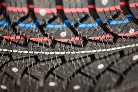 Studded tire on a background winter studded tires for a car new close-up
