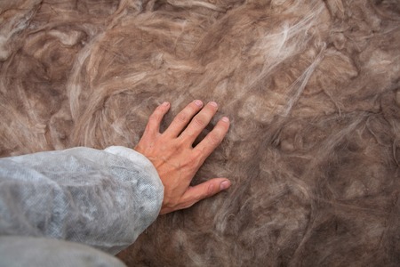 Mineral wool stack on construction site - thermal insulation of a house Soft eco-friendly insulation for the roof is safe for the hands skinの写真素材