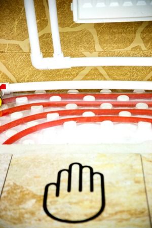 laying of pipes of a warm floor under a laminate of a parquet and a tile Floor heating pipe. Installation of engineering systems in a building.の写真素材