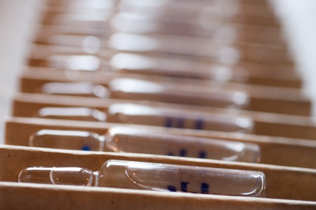 ampoules with medicine horizontal perspective view of many brown ampoules set in pharmaceutical packaging white containerの写真素材