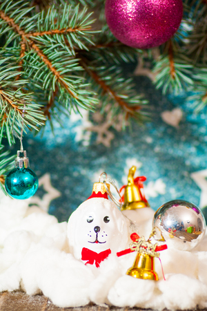 new year tree with toys background year dog new year toy in the shape of a dog on Christmas tree with balls and garlands background for cards.の写真素材