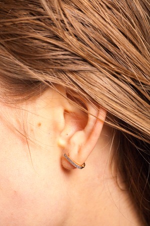 ear of a young healthy girl Detail of the head with female human ear and hair close upの写真素材