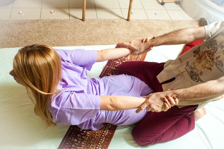 therapeutic massage manual therapy for curing pain in the joints of the osteochondrosis of the spine of muscle relaxationの写真素材