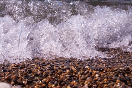 sea pebbles pebbles colored granite on the beach on the beach background Sea shells, corals, pebble...