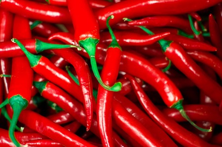 Red peppers background texture of hot red chili, seasoning paprika, fiery red hot in the kitchen a dish of red pepper for saleの写真素材