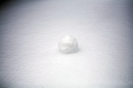 real snowballs with their hands clasped from the fresh snow in winter on the streetの写真素材