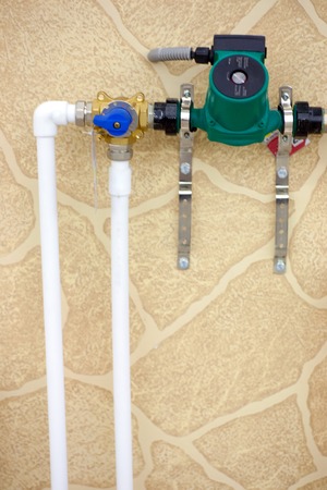 Circulation Pumps on theof pipes of a warm floor under a laminate of a parquet and a tile Floor heating pipe. Installation of engineering systems in a building.の写真素材