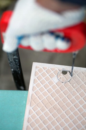 Laying ceramic tiles on the floor drilling of ceramic tilesの写真素材