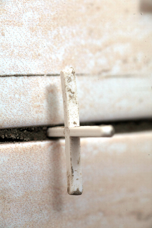 laying of tiles industrial construction worker installing small ceramic tiles on bathroom walls and applying mortar with trowelの写真素材