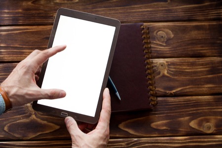 Digital tablet computer with isolated screen in male handsの写真素材