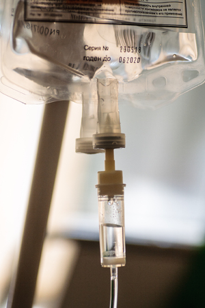 Dropper into a vein close-up in hospitalの写真素材