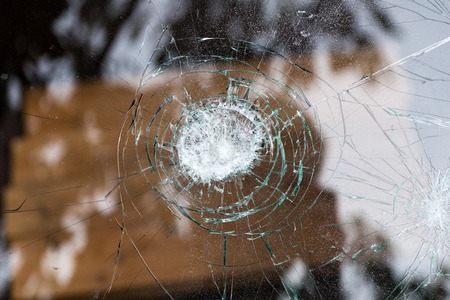 broken glass of a car with cracks in a circleの写真素材