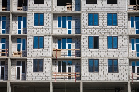 Construction of an apartment house. High concrete skyscraper with offices in the process of...