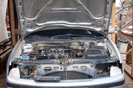mechanic men with wrench repairing car engine at workshop - auto service, repair, maintenance and...