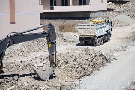 A large construction excavator of yellow color on the construction site in a quarry for quarryingの写真素材