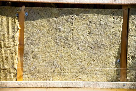 warming the walls of a stone house with a stone wool heater. Ecological insulation of rooms with...