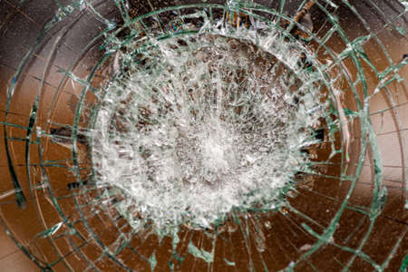 broken glass. Car glass cracked from an accident. Armored glass after impact. glass reinforced with a film after being hit by a bullet.の写真素材