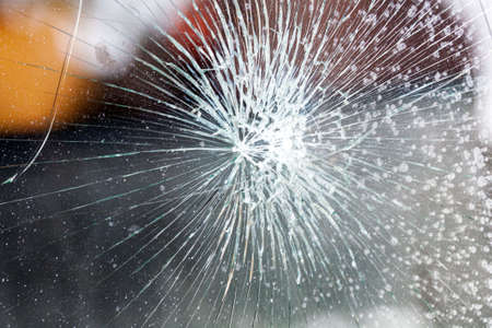 broken glass. Car glass cracked from an accident. Armored glass after impact. glass reinforced with a film after being hit by a bullet.の写真素材