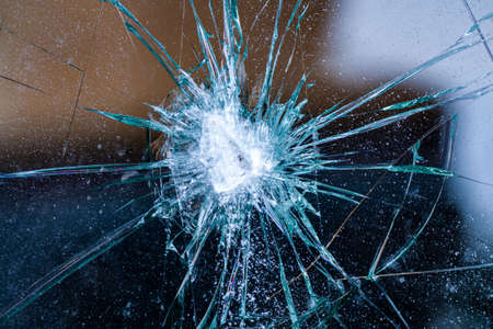 broken glass. Car glass cracked from an accident. Armored glass after impact. glass reinforced with a film after being hit by a bullet.の写真素材