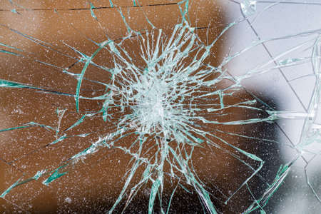 broken glass. Car glass cracked from an accident. Armored glass after impact. glass reinforced with a film after being hit by a bullet.の写真素材