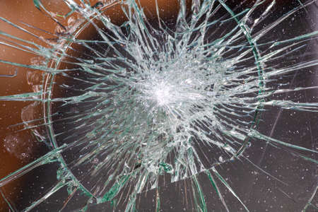 broken glass. Car glass cracked from an accident. Armored glass after impact. glass reinforced with a film after being hit by a bullet.の写真素材