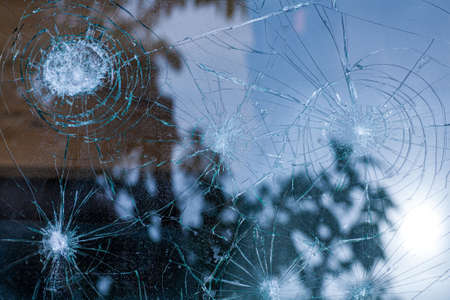 broken glass. Car glass cracked from an accident. Armored glass after impact. glass reinforced with a film after being hit by a bullet.の写真素材
