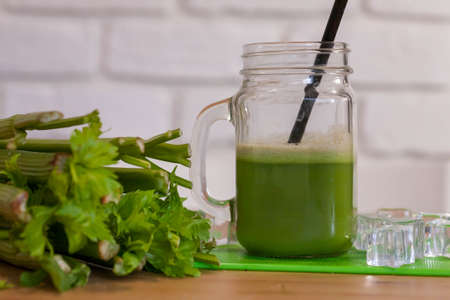 Healthy Celery diet for the treatment of incurable mysterious diseases. Fresh celery juice squeezed out on a juicer.drink, vegetable juice, studio shotの写真素材