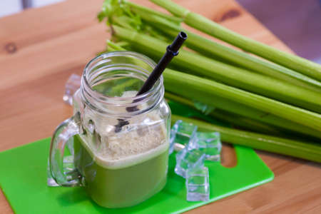Healthy Celery diet for the treatment of incurable mysterious diseases. Fresh celery juice squeezed out on a juicer.drink, vegetable juice, studio shotの写真素材