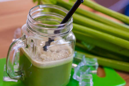 Healthy Celery diet for the treatment of incurable mysterious diseases. Fresh celery juice squeezed out on a juicer.drink, vegetable juice, studio shotの写真素材