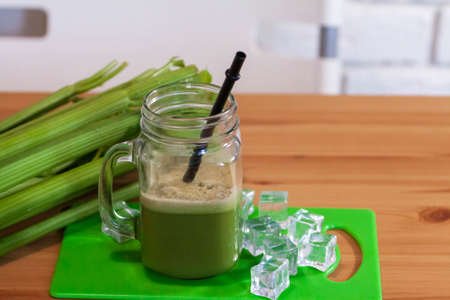 Healthy Celery diet for the treatment of incurable mysterious diseases. Fresh celery juice squeezed out on a juicer.drink, vegetable juice, studio shotの写真素材