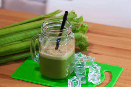 Healthy Celery diet for the treatment of incurable mysterious diseases. Fresh celery juice squeezed out on a juicer.drink, vegetable juice, studio shotの写真素材