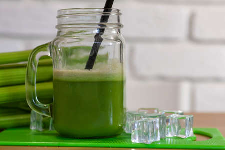 Healthy Celery diet for the treatment of incurable mysterious diseases. Fresh celery juice squeezed out on a juicer.drink, vegetable juice, studio shotの写真素材
