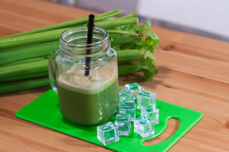 Healthy Celery diet for the treatment of incurable mysterious diseases. Fresh celery juice squeezed out on a juicer.drink, vegetable juice, studio shotの写真素材