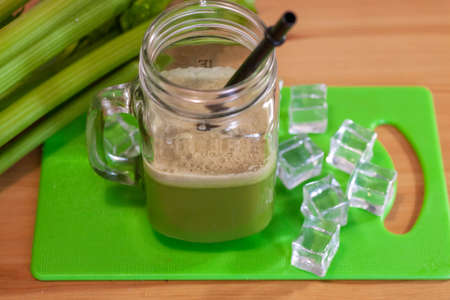 Healthy Celery diet for the treatment of incurable mysterious diseases. Fresh celery juice squeezed out on a juicer.drink, vegetable juice, studio shotの写真素材