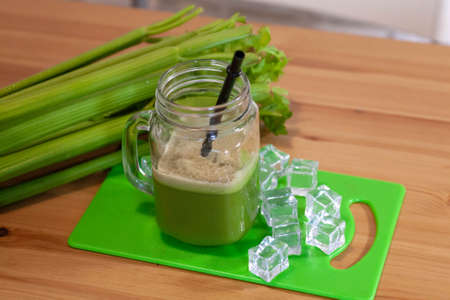 Healthy Celery diet for the treatment of incurable mysterious diseases. Fresh celery juice squeezed out on a juicer.drink, vegetable juice, studio shotの写真素材