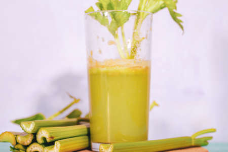 Healthy Celery diet for the treatment of incurable mysterious diseases. Fresh celery juice squeezed out on a juicer.drink, vegetable juice, studio shotの写真素材