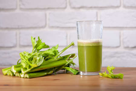 Healthy Celery diet for the treatment of incurable mysterious diseases. Fresh celery juice squeezed out on a juicer.drink, vegetable juice, studio shotの写真素材