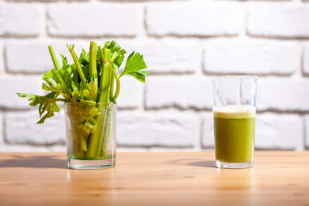Healthy Celery diet for the treatment of incurable mysterious diseases. Fresh celery juice squeezed out on a juicer.drink, vegetable juice, studio shotの写真素材