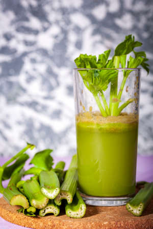 Healthy Celery diet for the treatment of incurable mysterious diseases. Fresh celery juice squeezed out on a juicer.drink, vegetable juice, studio shotの写真素材