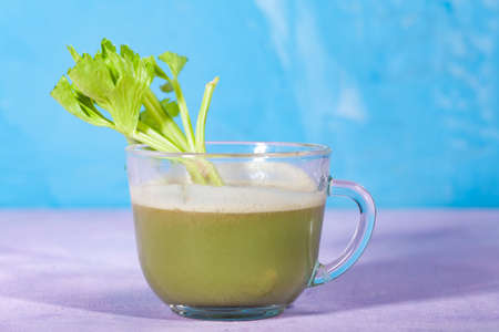 Healthy Celery diet for the treatment of incurable mysterious diseases. Fresh celery juice squeezed out on a juicer.drink, vegetable juice, studio shotの写真素材
