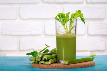 Healthy Celery diet for the treatment of incurable mysterious diseases. Fresh celery juice squeezed out on a juicer.drink, vegetable juice, studio shotの写真素材