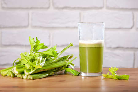 Healthy Celery diet for the treatment of incurable mysterious diseases. Fresh celery juice squeezed out on a juicer.drink, vegetable juice, studio shotの写真素材