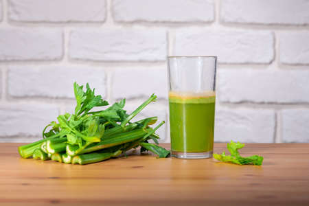 Healthy Celery diet for the treatment of incurable mysterious diseases. Fresh celery juice squeezed out on a juicer.drink, vegetable juice, studio shotの写真素材