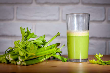 Healthy Celery diet for the treatment of incurable mysterious diseases. Fresh celery juice squeezed out on a juicer.drink, vegetable juice, studio shotの写真素材